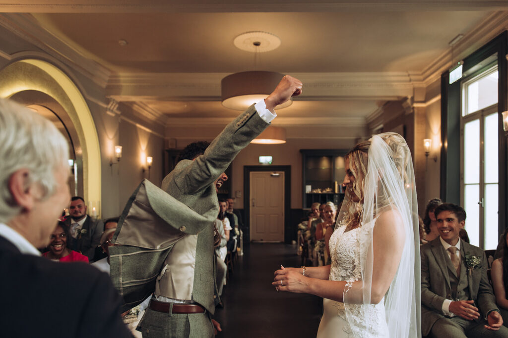 Groom triumphantly punching the air officially married
