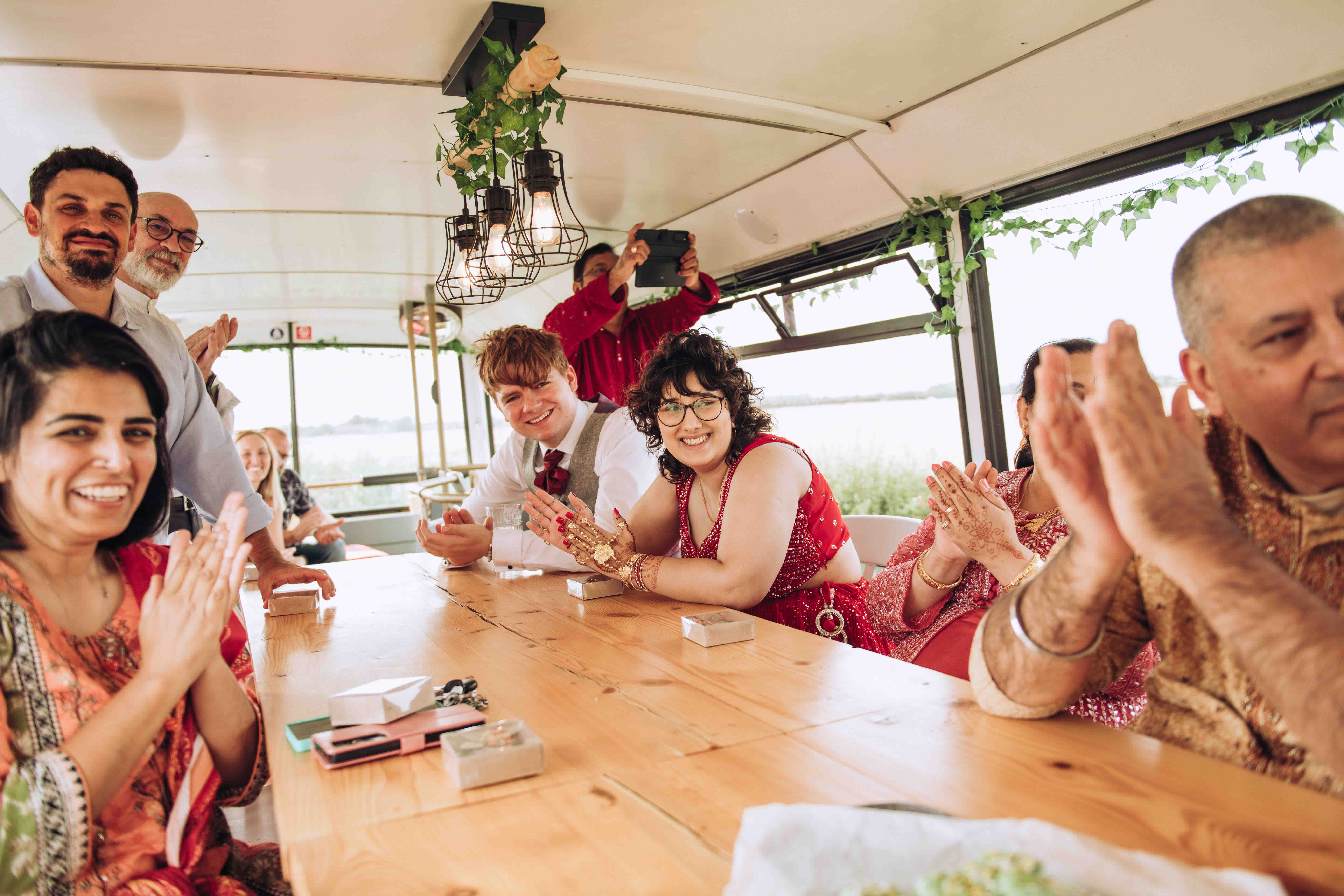 Wedding guests clapping on bus