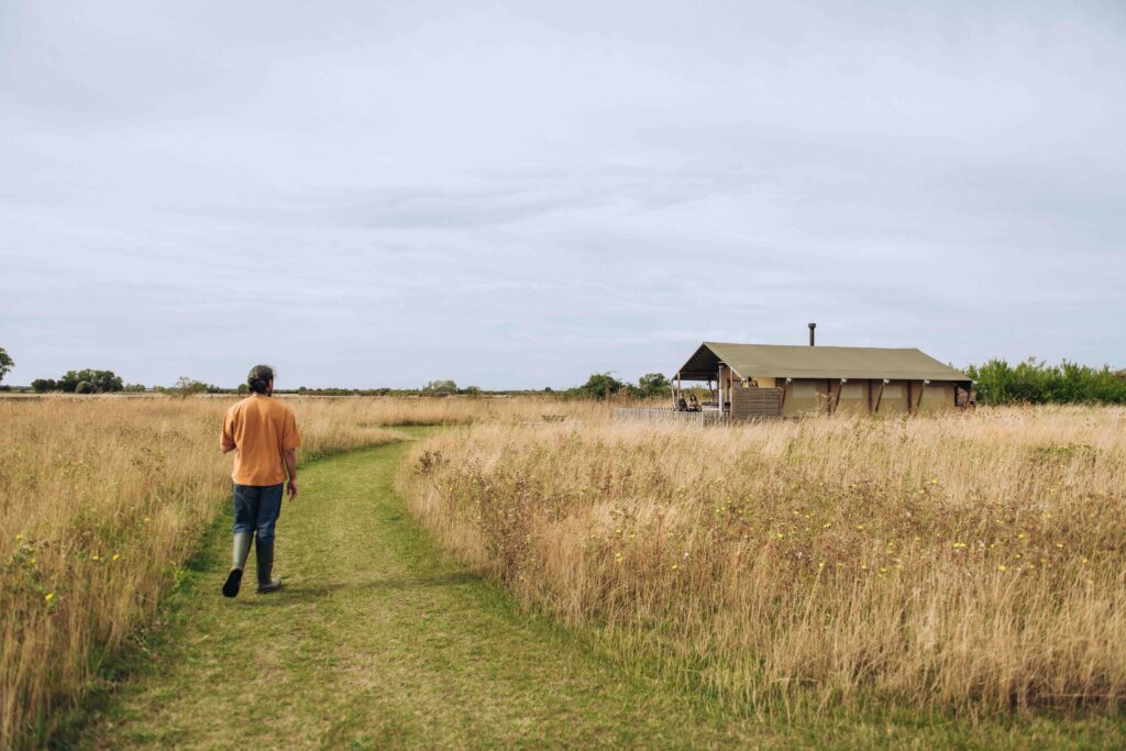 Groom walking to glamping tent