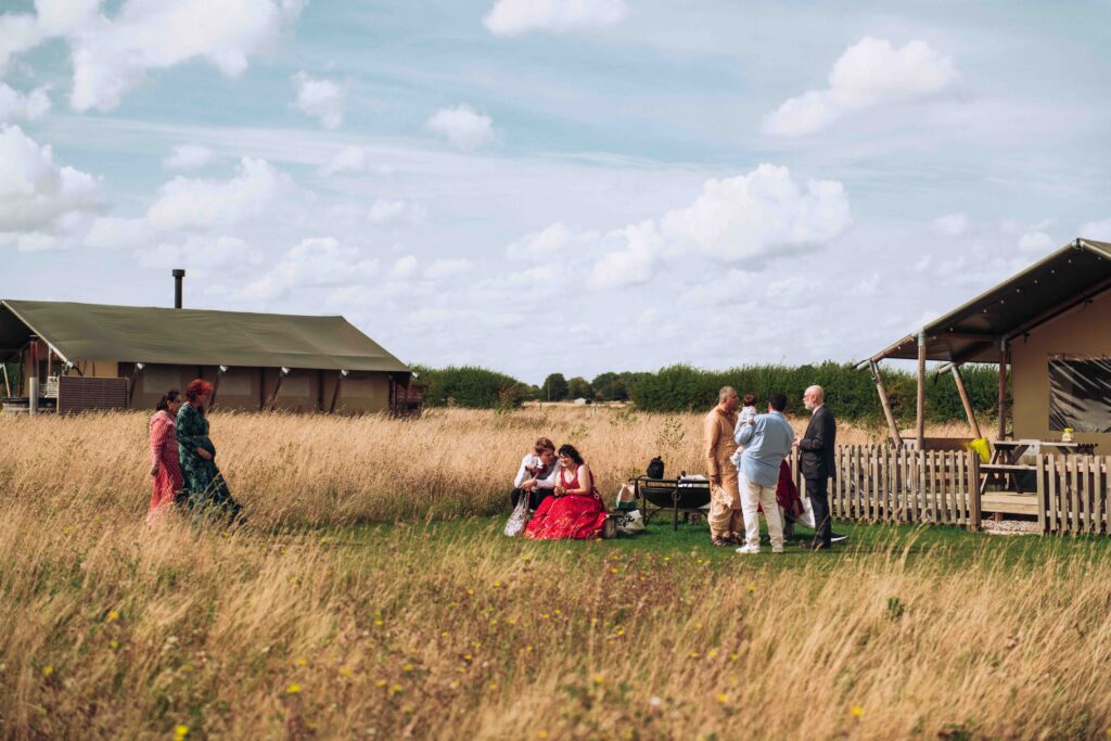 Guests gathering by tent at micro wedding