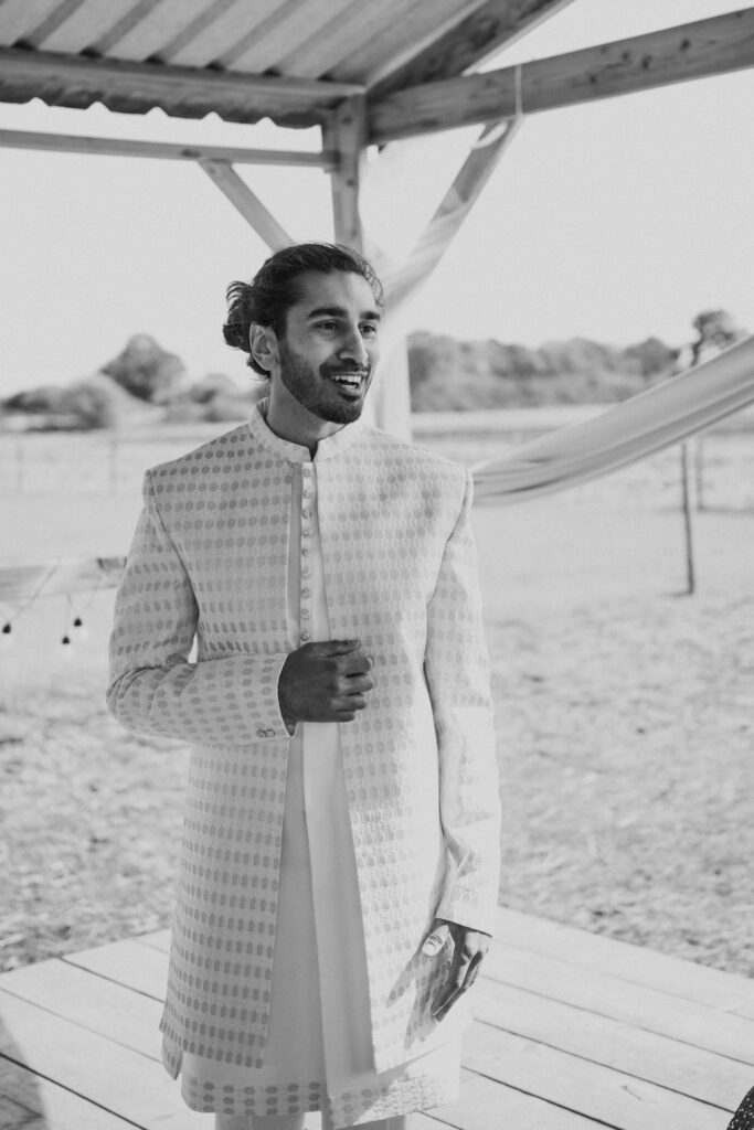 Groom laughing at wedding
