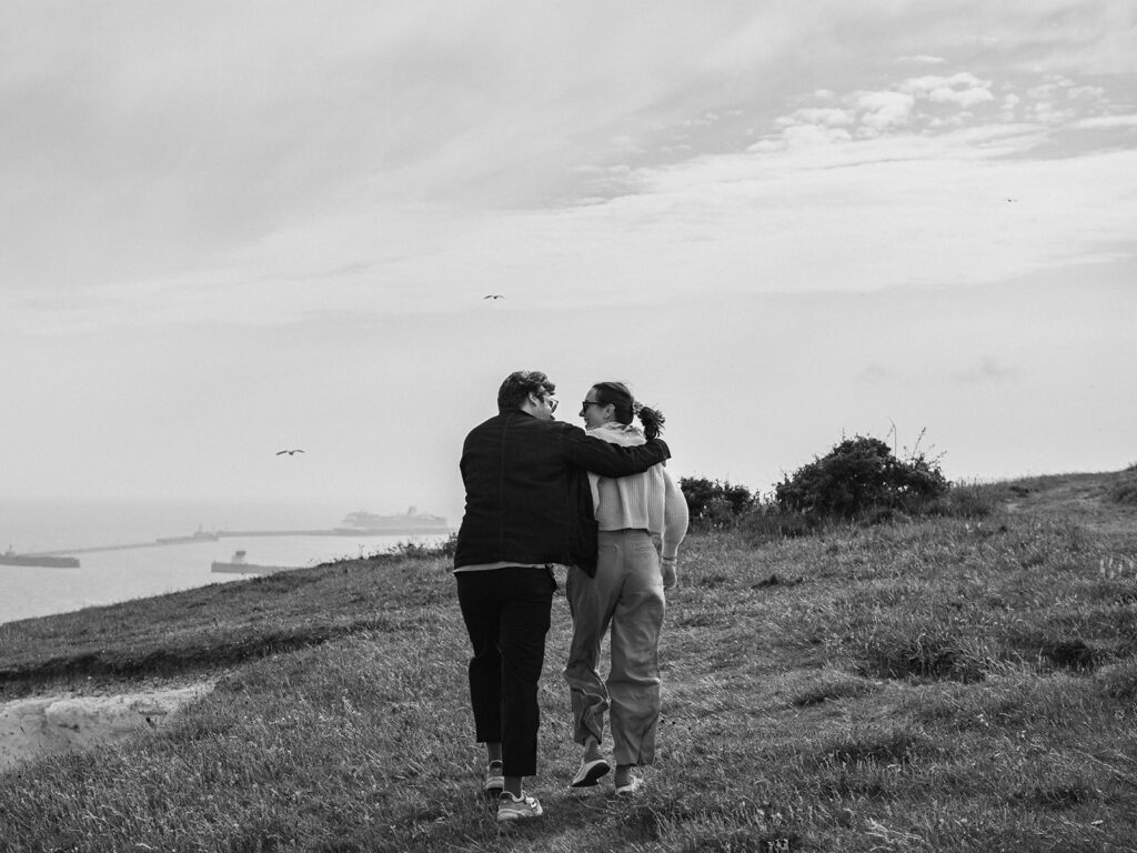 Newly engaged couple walking by the cliffs in Dover