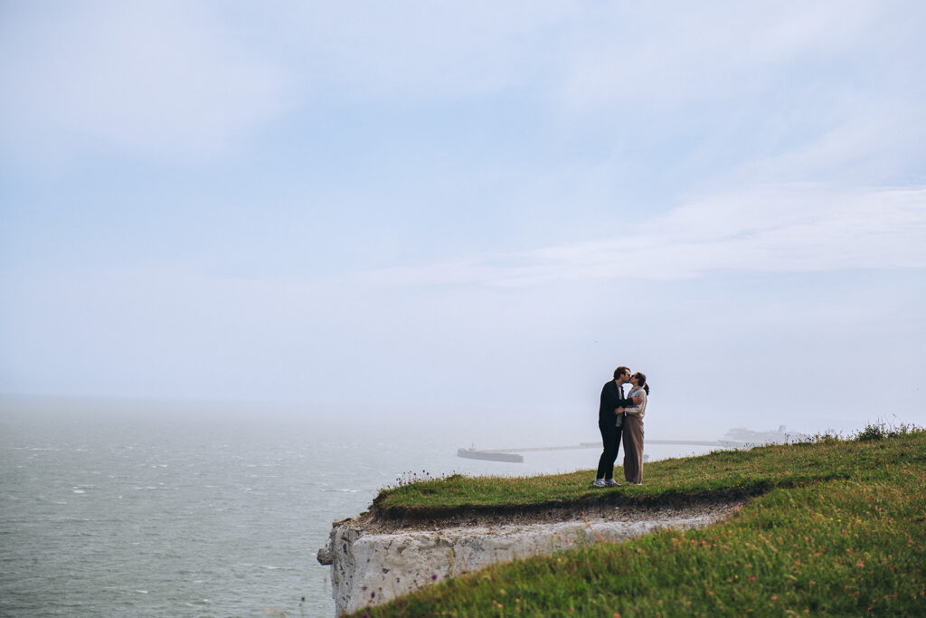 Couple kissing on the cliffs of Dover