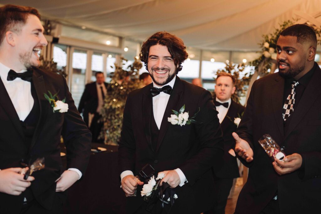 Grooms laughing at wedding