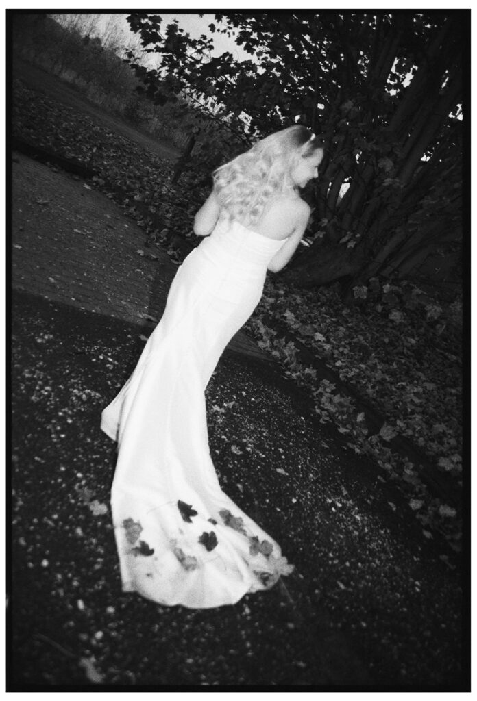 Editorial analogue portrait of leaves on wedding dress