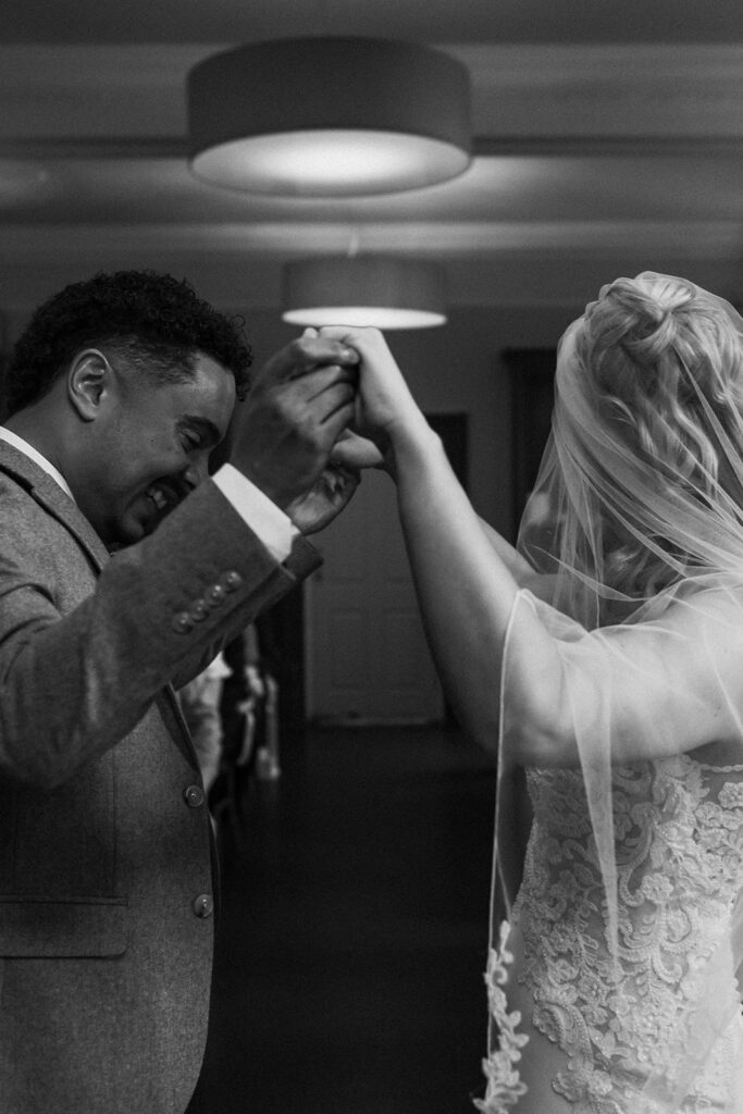 Bride and groom holding hands in air