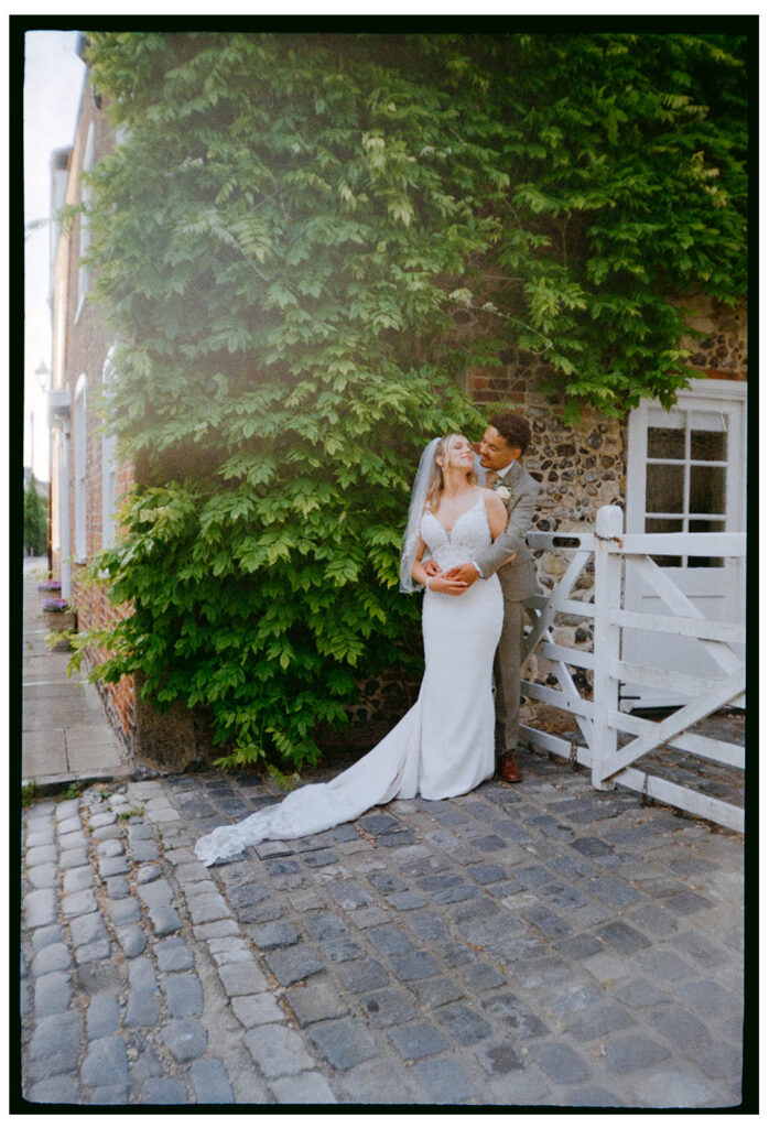 35mm film scan of cuddling bride and groom