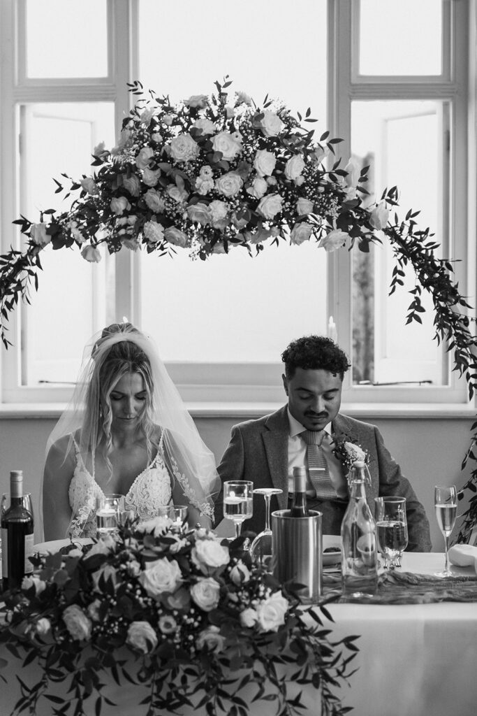 Bride and groom being prayed for at wedding
