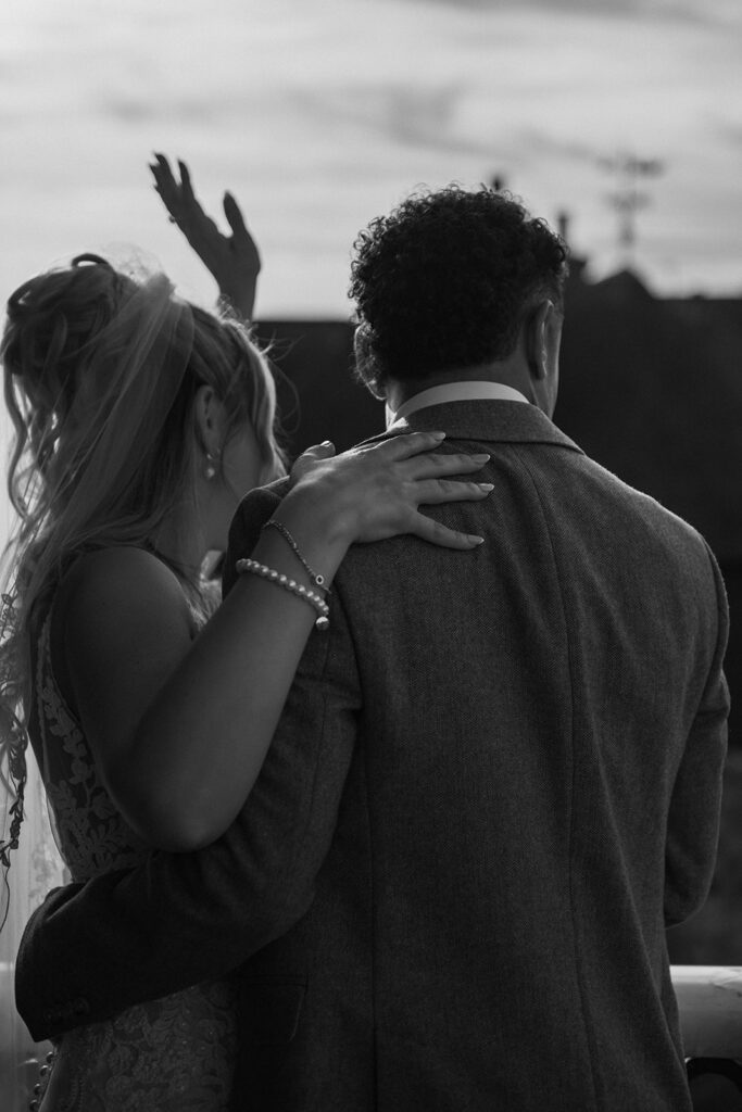 Newlyweds waving from balcony