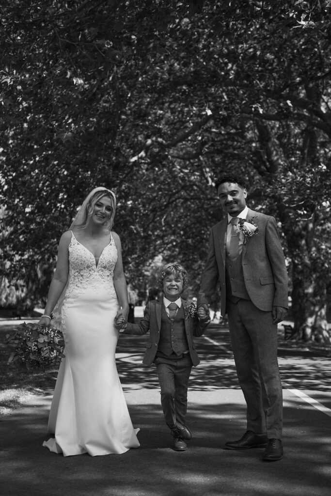 Mother father and son in park on wedding day