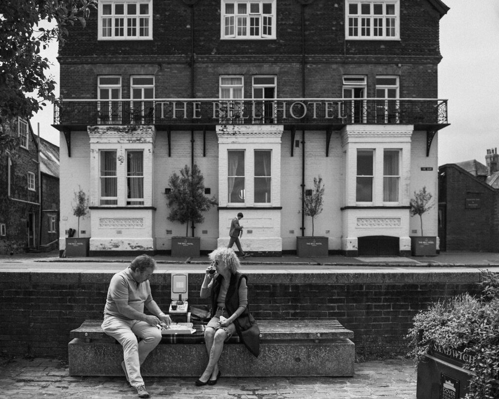 people eating pizza outside the bell hotel in sandwich