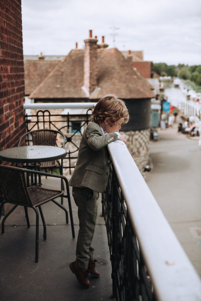 son looking over balcony