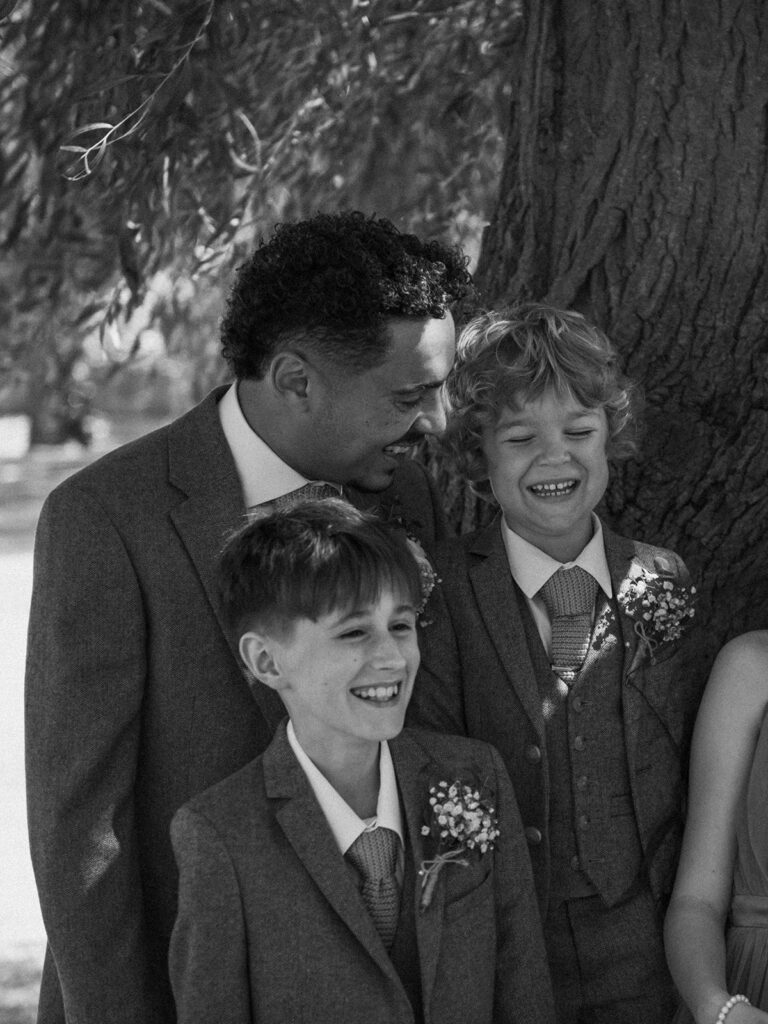 Groom and sons laughing by the quay in Sandwich