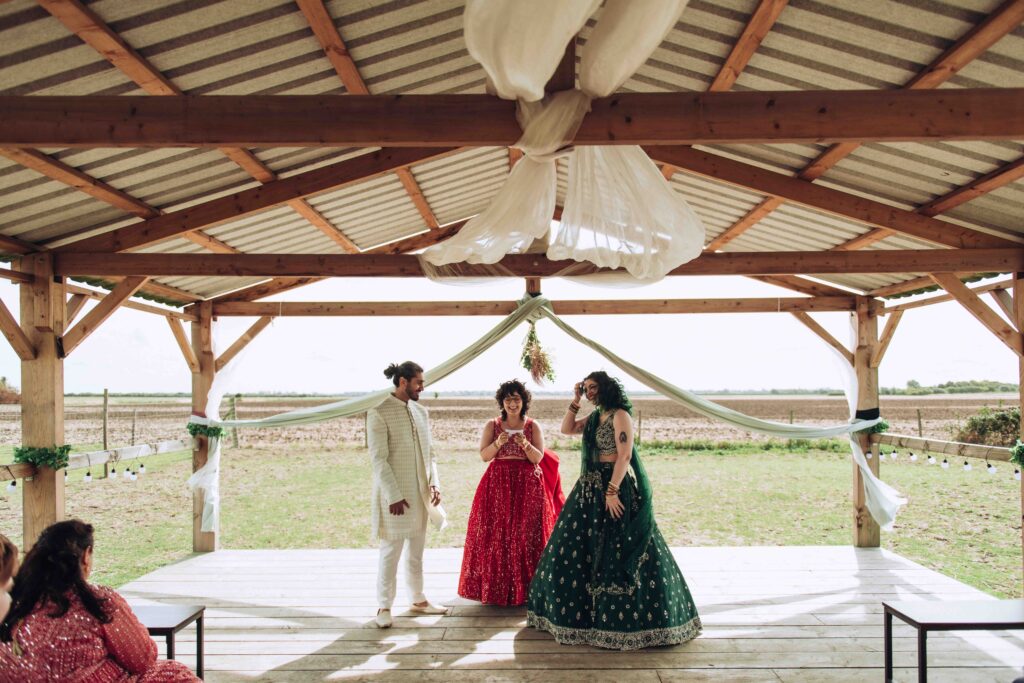 Bride and groom making vows at their wedding in a barn
