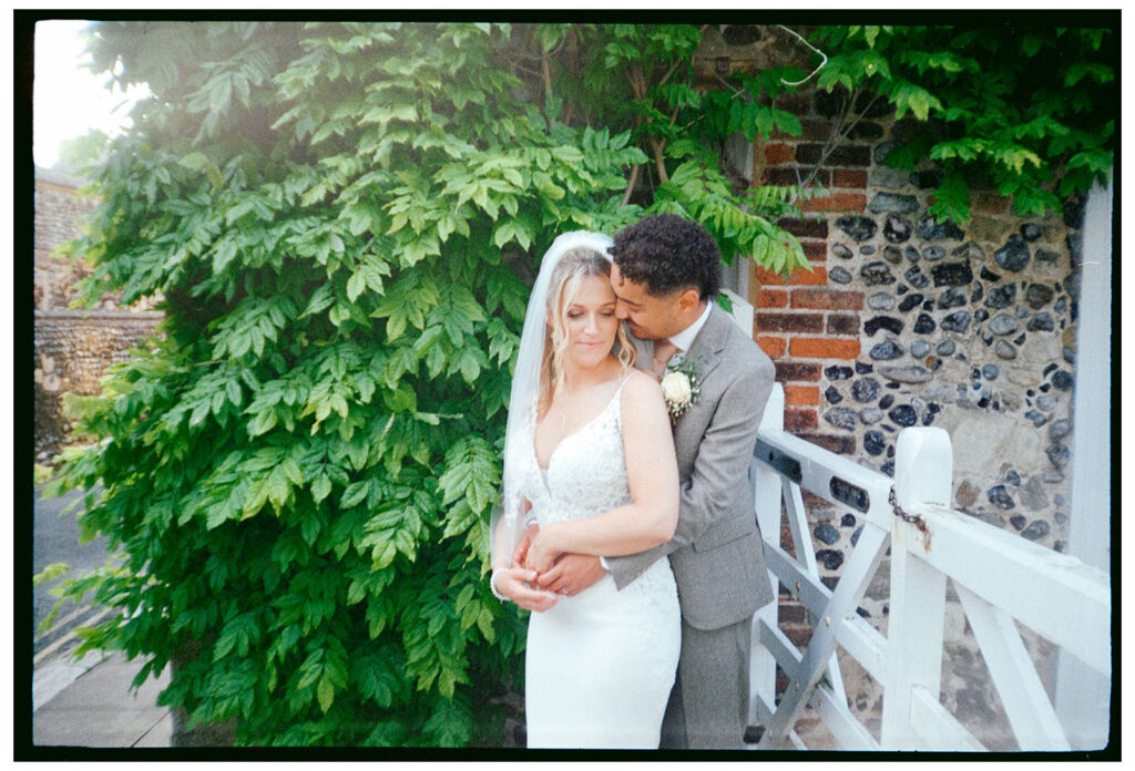 35mm film scan of cuddling bride and groom