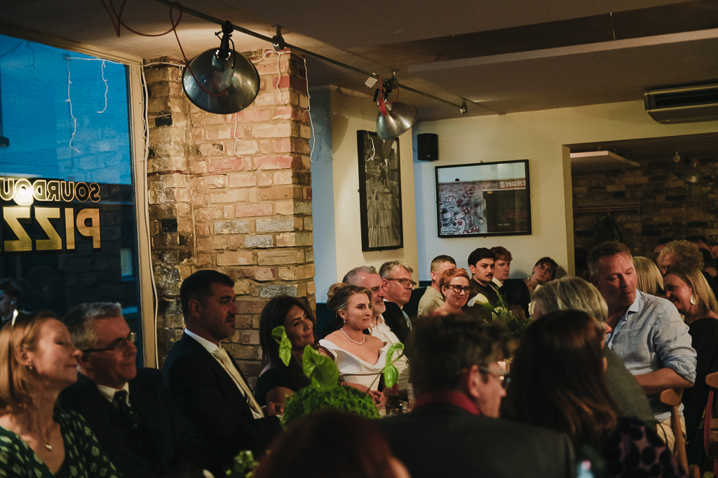 Bride and groom listening to speech