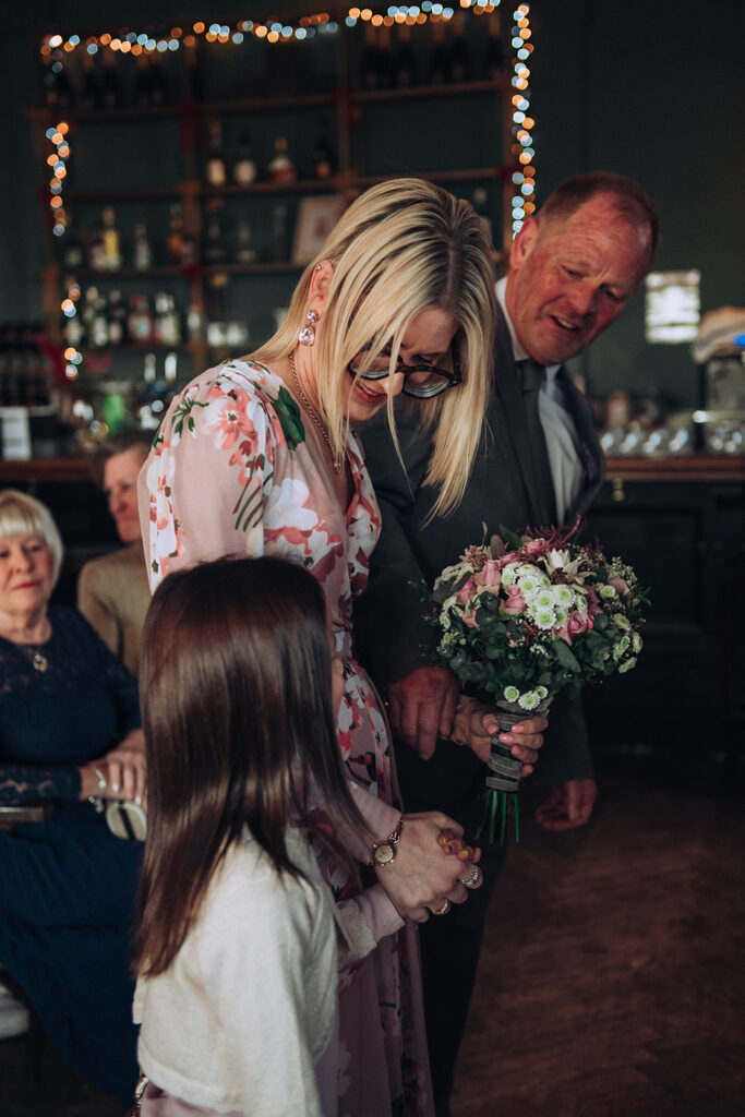 Bride being handed over at wedding by father