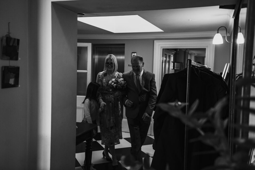 Bride, father and daughter walking into wedding