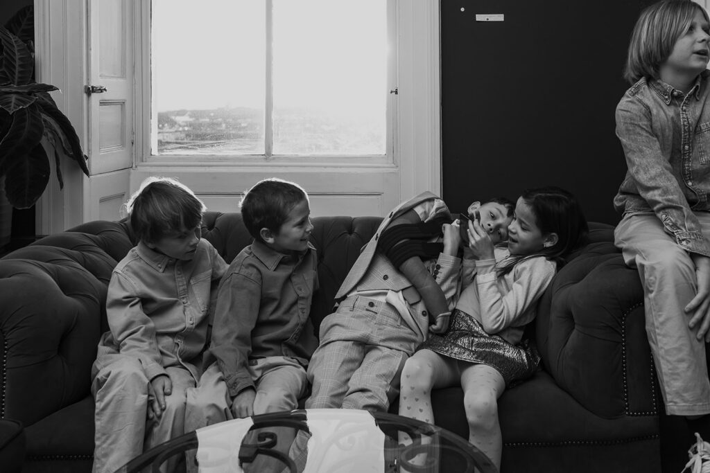 Children playing on phone at wedding