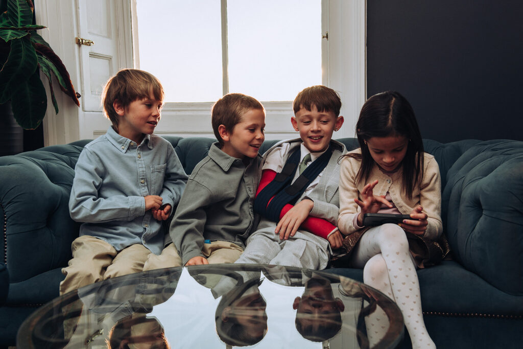 Kids playing on a phone at a wedding