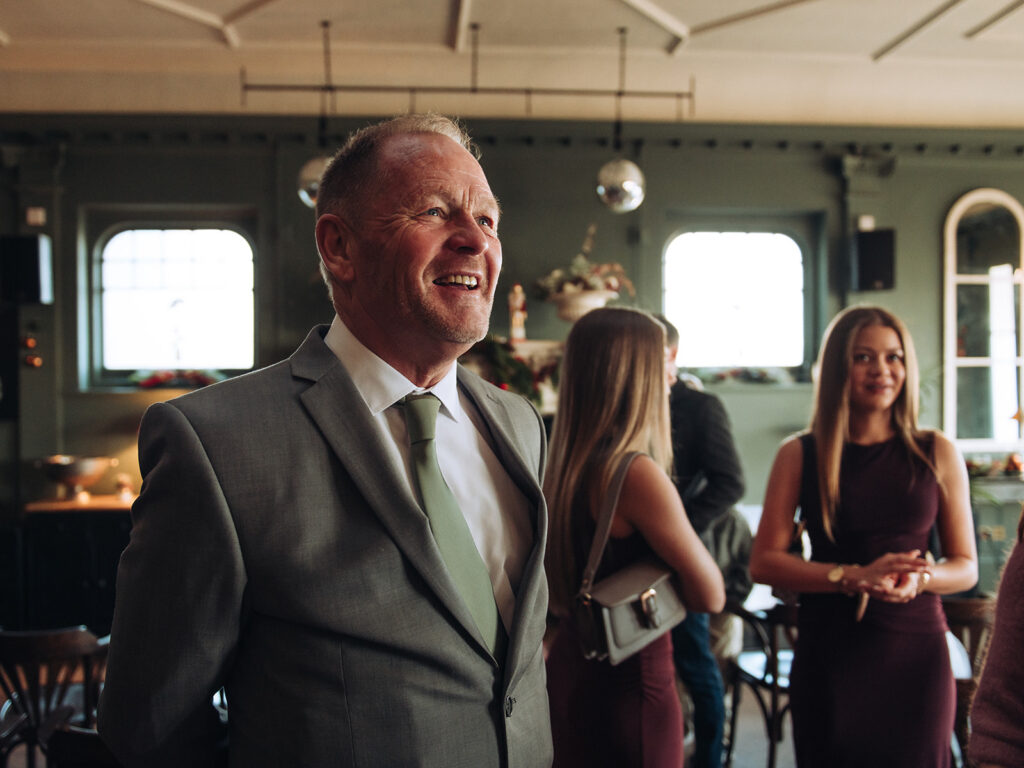 Father of bride laughing at a wedding