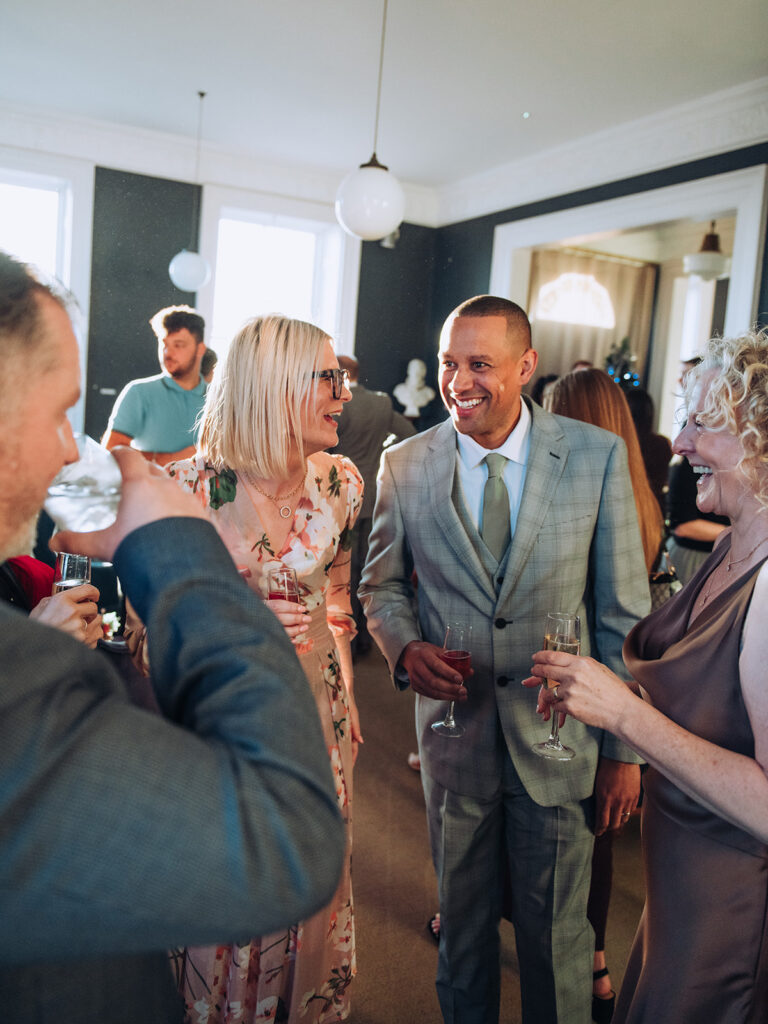 Bride and groom laughing with wedding guests