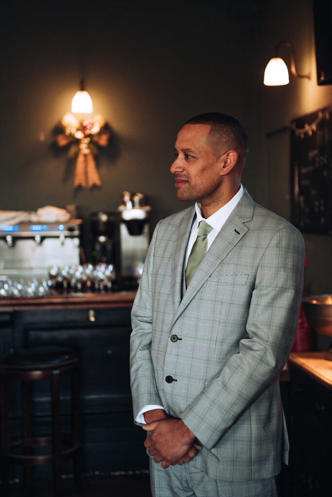 Groom waiting for bride at end of aisle at wedding