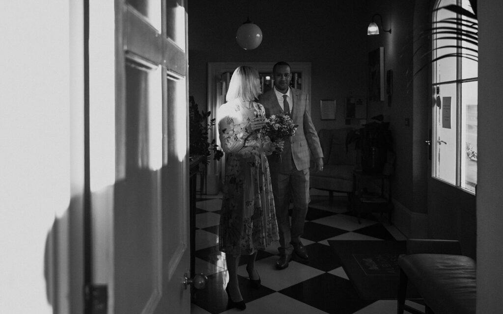 Editorial portrait of bride and groom walking through the house in Ramsgate