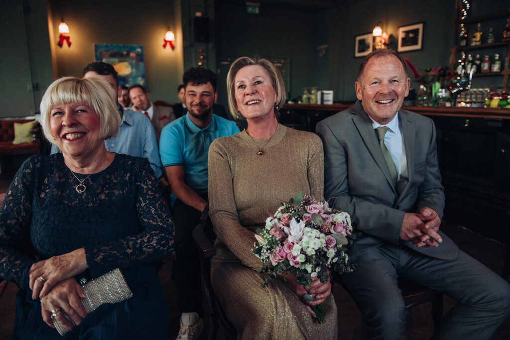 Parents of bride laughing at ceremony