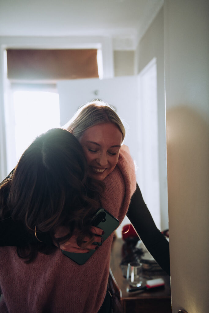 bridesmaids cuddling at wedding