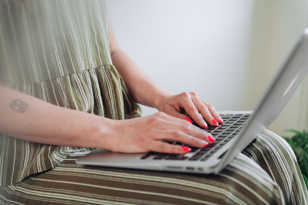 Therapist branding photography as a cbt practitioner types notes on laptop
