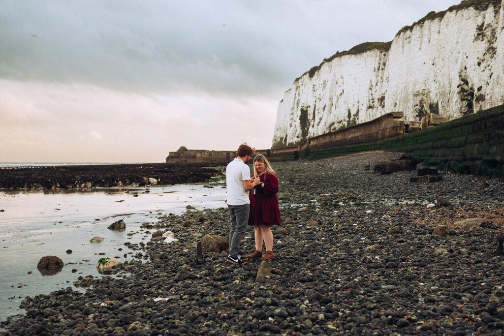 Man and women on the beach getting engaged in Kent