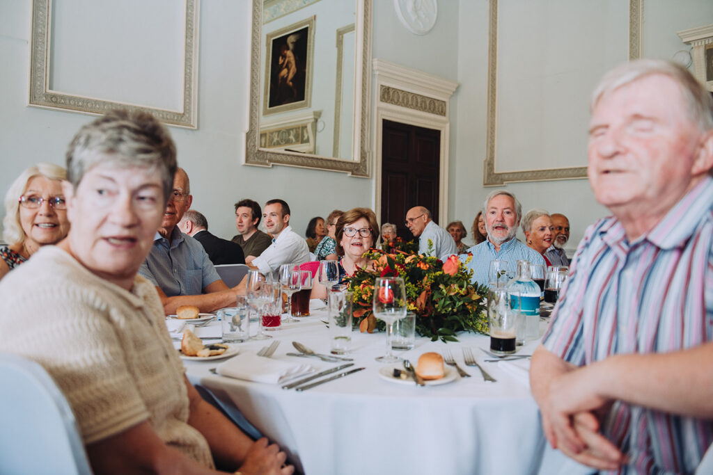 Guests listening to speech at party