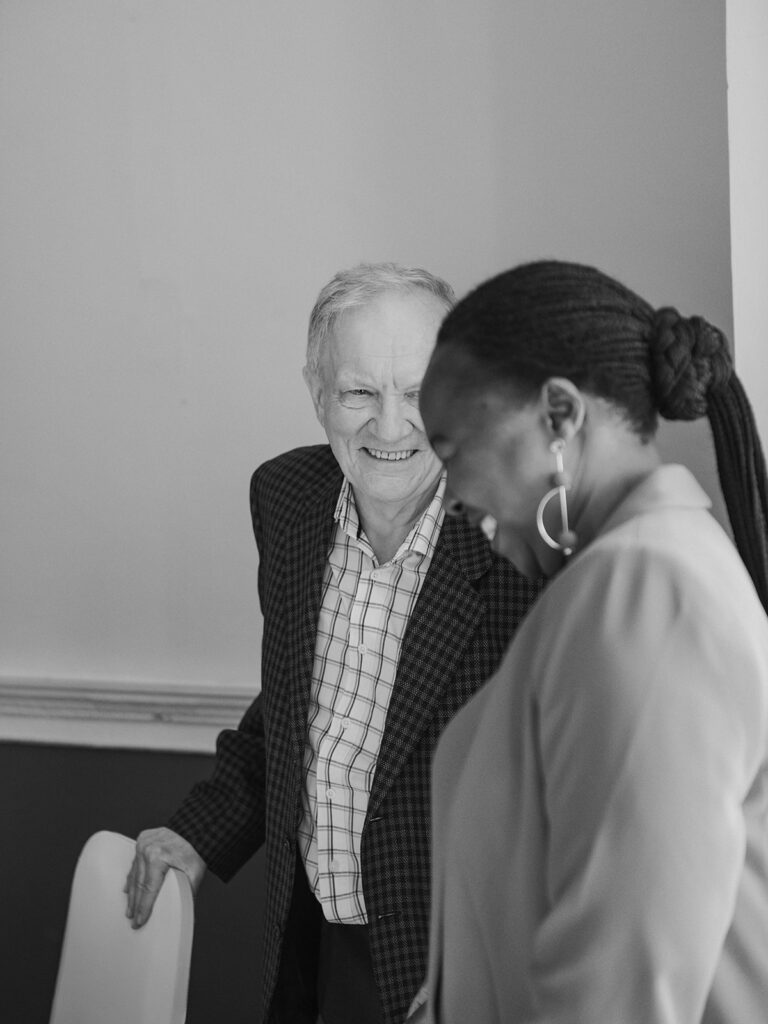 Man laughing with carer