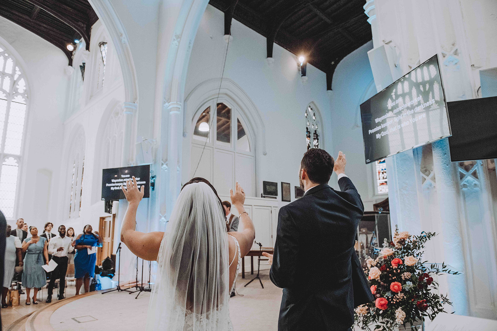 Couple worshipping Jesus in Church during their wedding in Cambridge