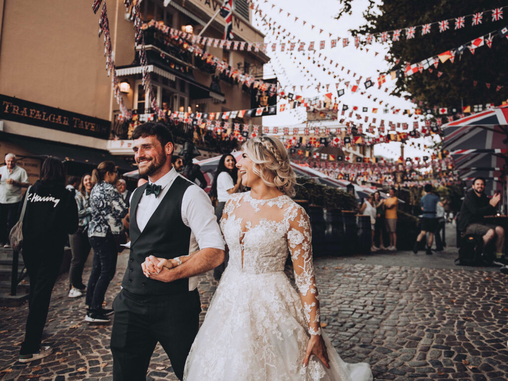 Newlywed couple walking in front of the Trafalgar Tavern