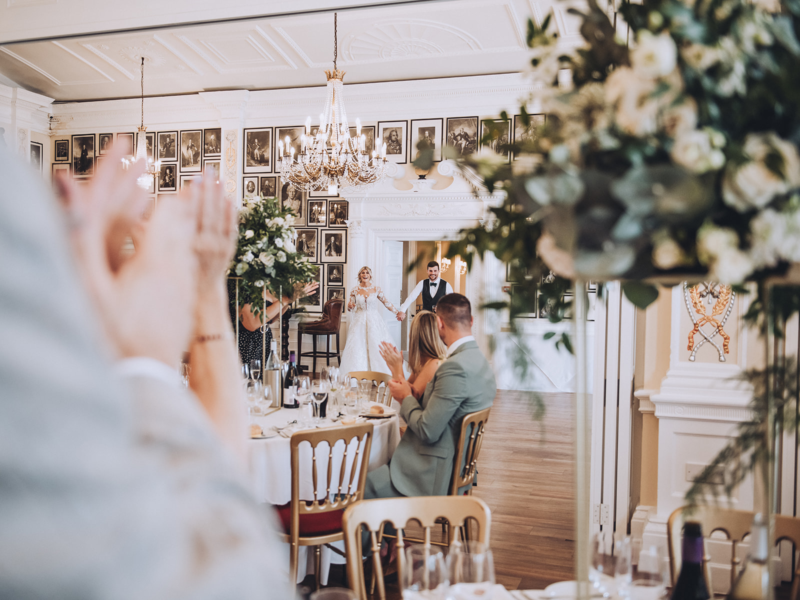 Bride and groom walking into their luxury wedding venue