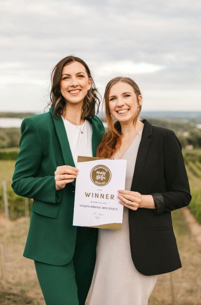 Vicki's Bridal Boutique owners holding their Muddy Stilettos award