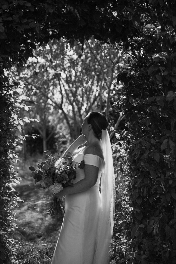 A bride caught off guard at her luxury wedding venue, behind the scenes of Editorial Wedding Photography: A Luxury Couple's Shoot