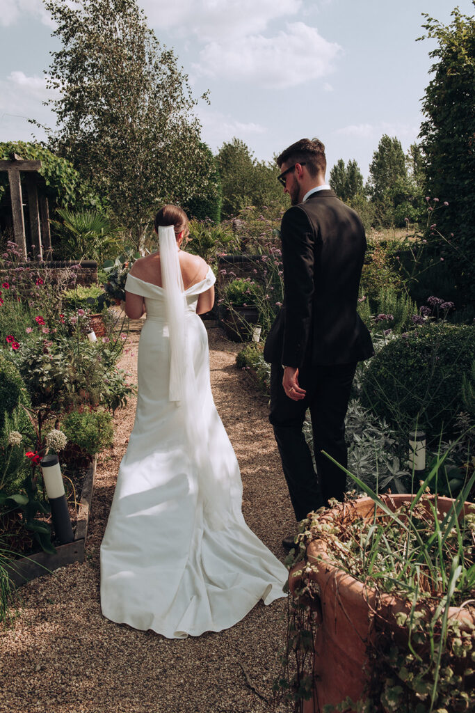 A photograph of a couple walking around the their luxury wedding venue, behind the scenes of Editorial Wedding Photography: A Luxury Couple's Shoot