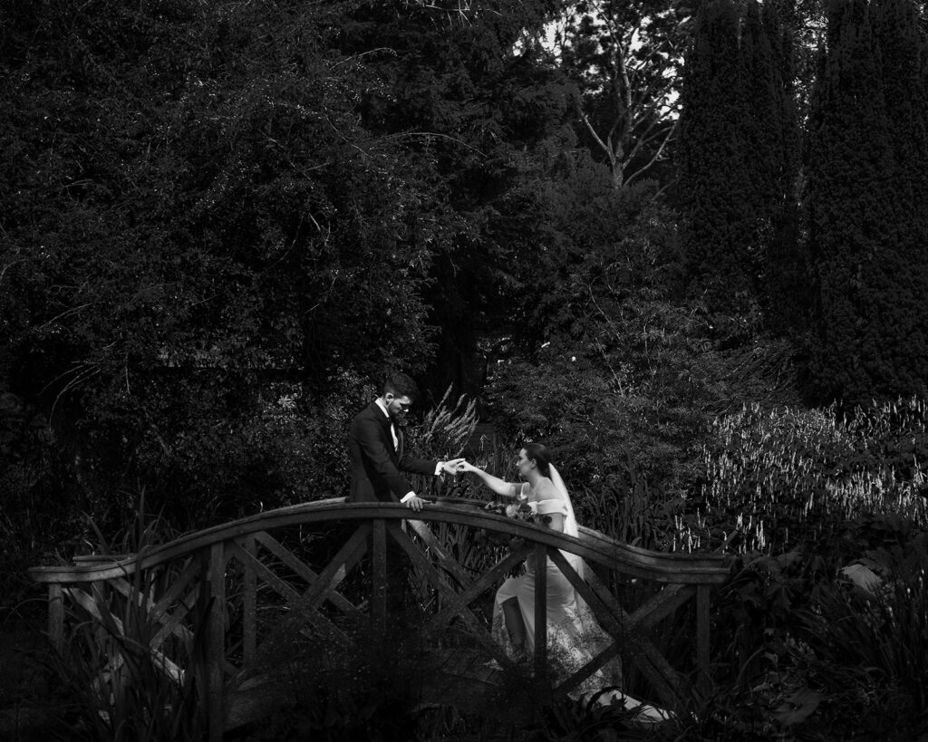 A couple walking on a bridge at their luxury wedding venue, behind the scenes of Editorial Wedding Photography: A Luxury Couple's Shoot