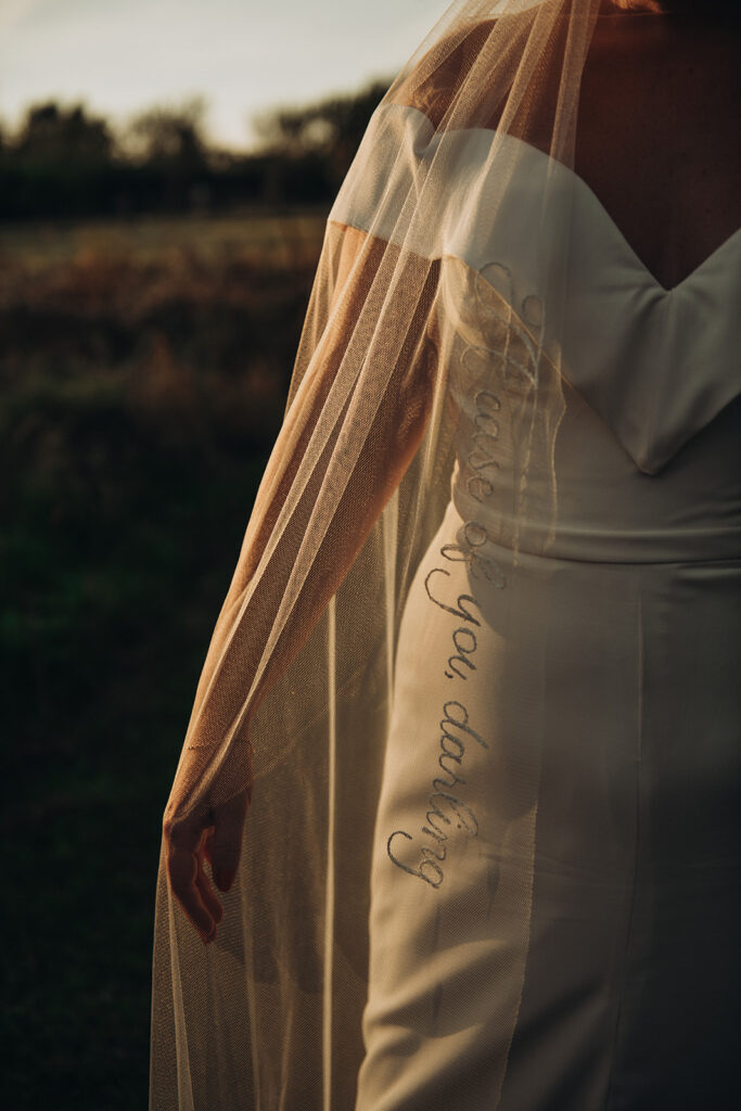 A bride showcasing her veil during sunset at their luxury wedding venue