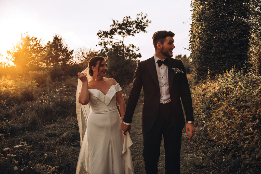 A couple chatting to guests during sunset at their luxury wedding venue