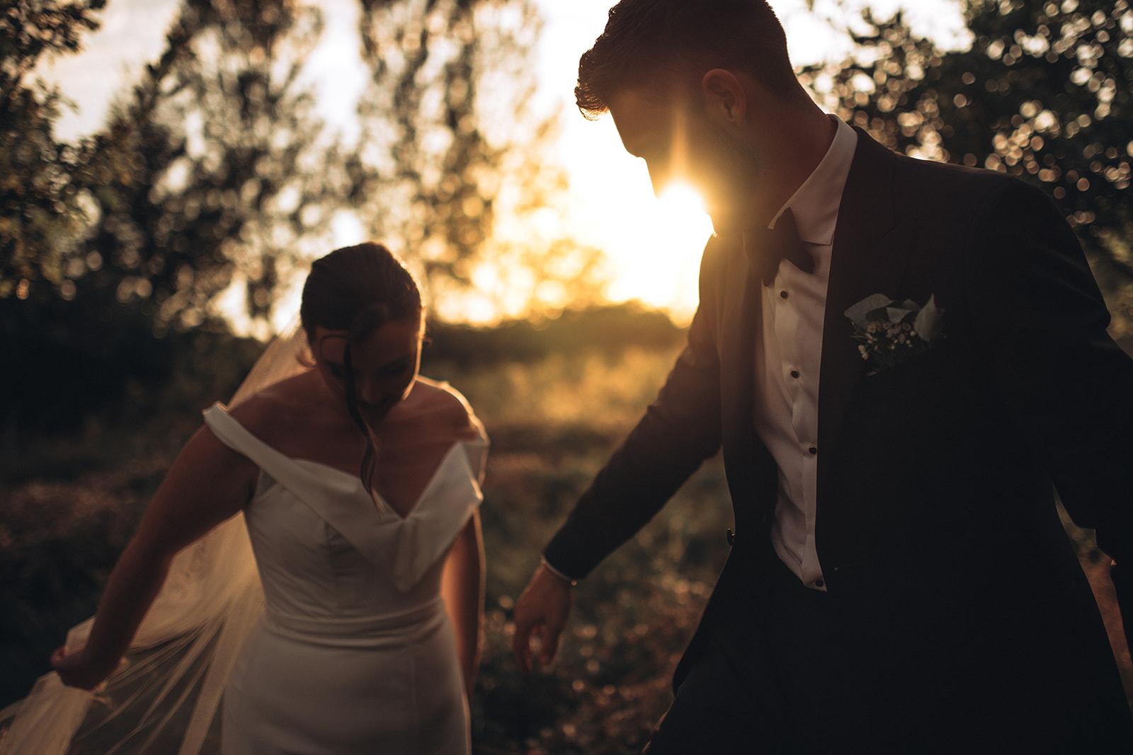 A couple dancing in wildflowers during sunset at their luxury wedding venue