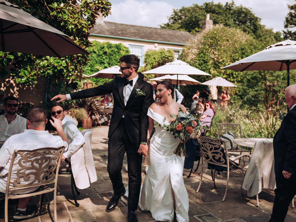 A couple greeting family at their luxury wedding venue, behind the scenes of Editorial Wedding Photography: A Luxury Couple's Shoot