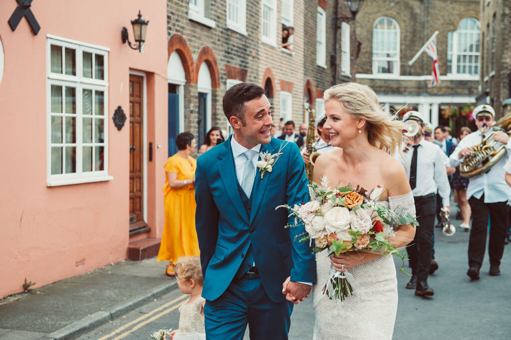 Newlywed couple and their daughter walking through Middle Street to the beach in Deal Kent