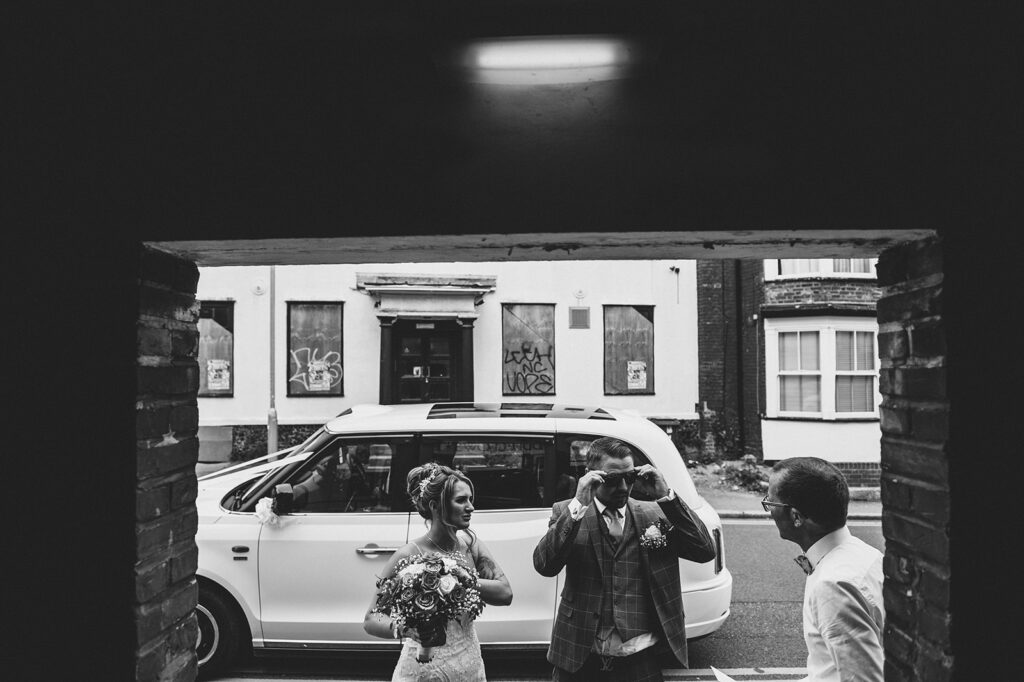 Couple arriving by taxi at their wedding in Sandwich