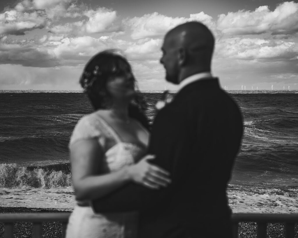 Newlywed couple hugging on the beach in Margate at their wedding