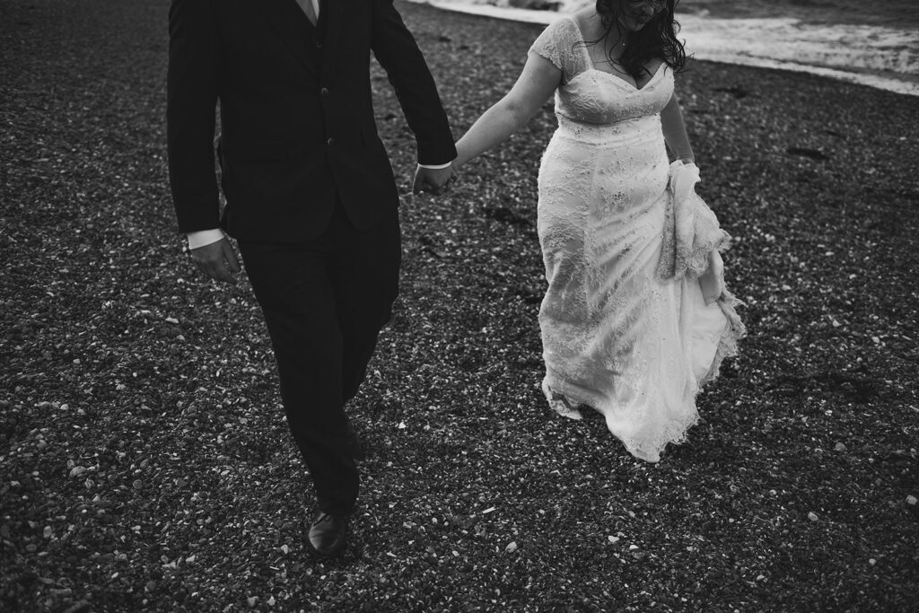 Newlywed couple walking along the beach in Margate at their wedding