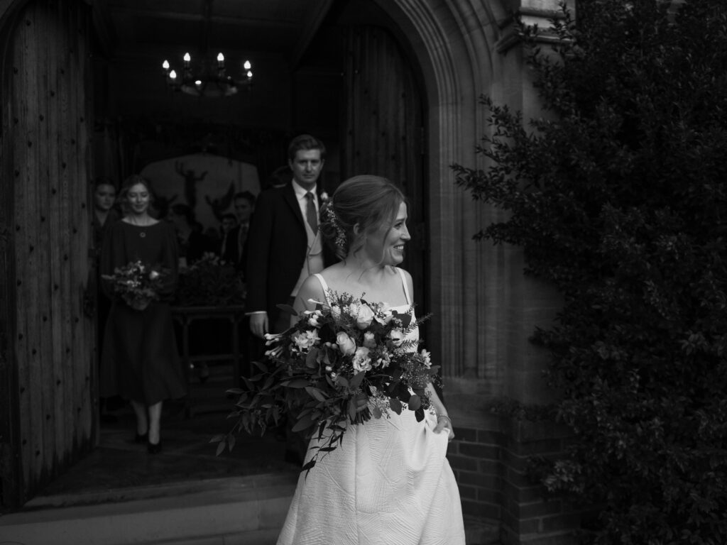 Bride walking out of church in Cambridge